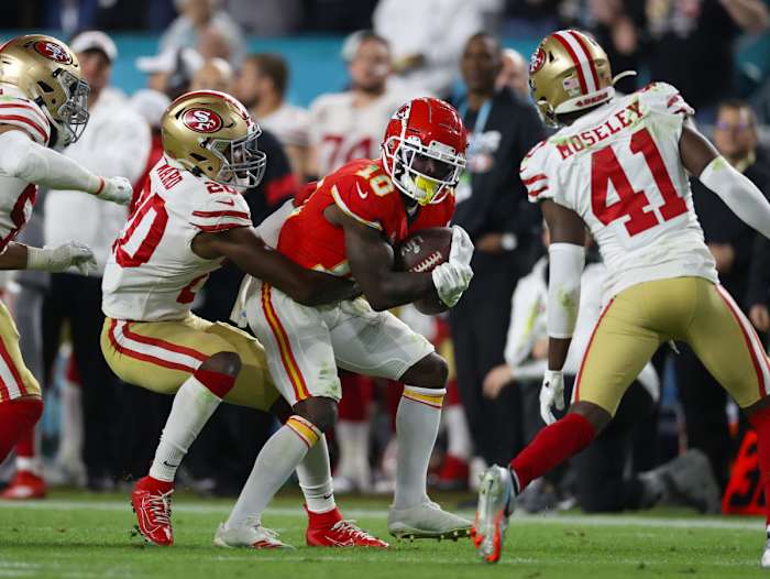 Feb 2, 2020; Miami Gardens, Florida, USA; Kansas City Chiefs receiver Tyreek Hill (10) runs after a reception against San Francisco 49ers safety Jimmie Ward (20) and cornerback Emmanuel Moseley (41) in Super Bowl LIV at Hard Rock Stadium. Mandatory Credit: Matthew Emmons-USA TODAY Sports